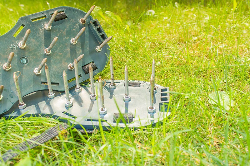 Shoes with spikes to aerate lawn soil